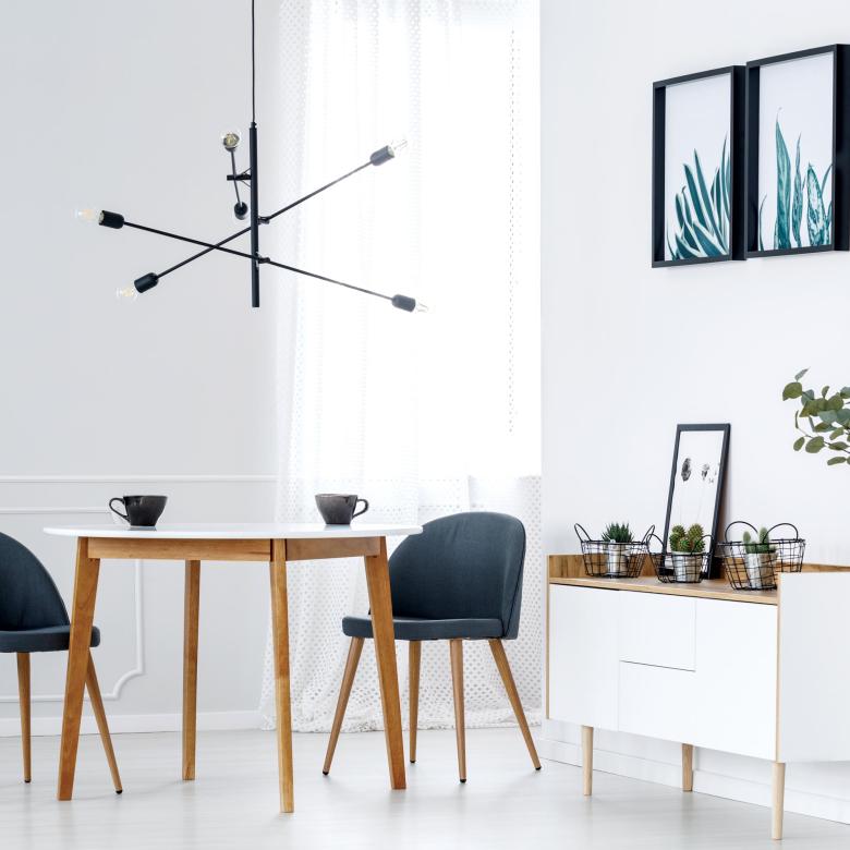 A modern dining area with table, chairs and sideboard